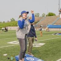 Megan Koeman-Eding jumping up excitedly with her fists in the air